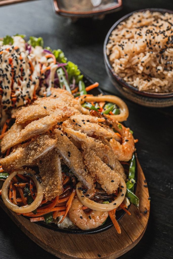 Breaded chicken and seafood with vegetables and rice