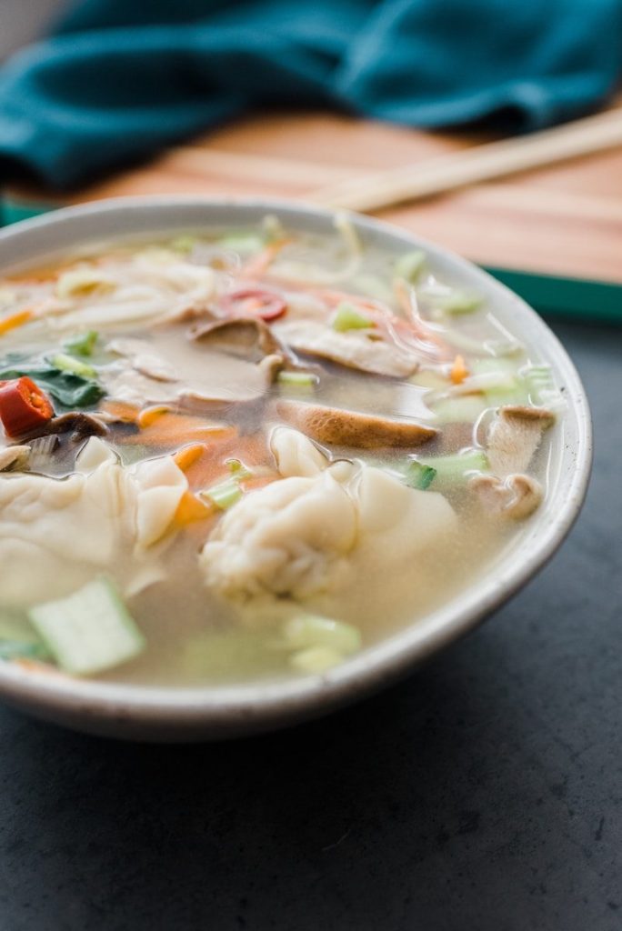 soup with meat and vegetables in white ceramic bowl